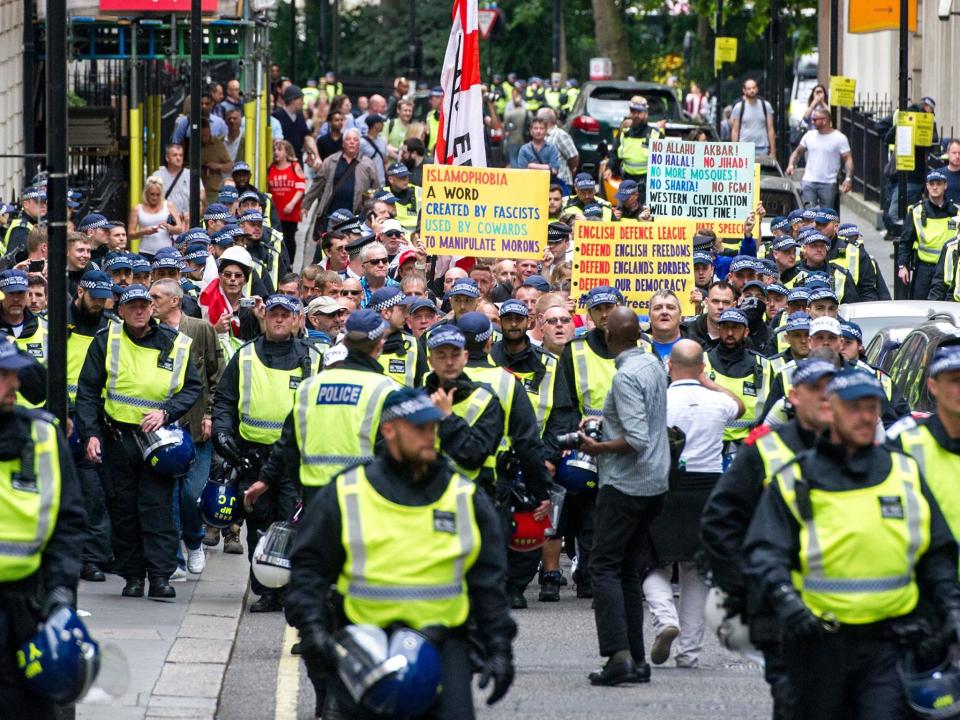 Members of the far-right anti-immigration English Defence League (EDL) march from Victoria Embankment to Charing Cross Station under heavy police guard, in Londnon: EPA/PETE MACLAINE