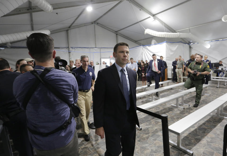 U.S. Department of Homeland Security Acting Secretary Kevin McAleenan, center, and other officials, tour the Migration Protection Protocols Immigration Hearing Facility, Tuesday, Sept. 17, 2019, in Laredo, Texas. (AP Photo/Eric Gay)