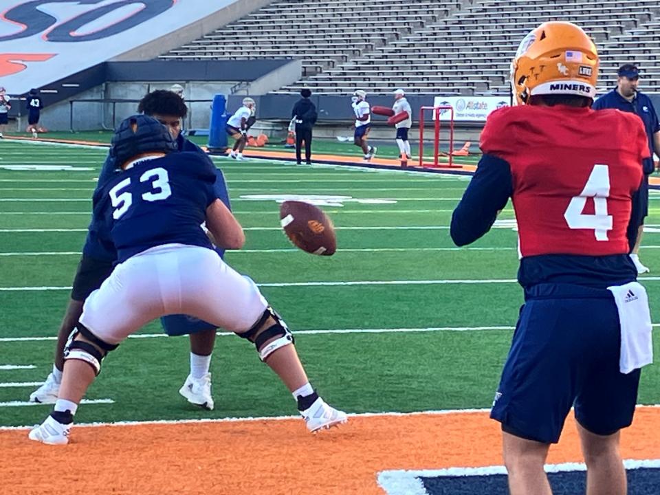 UTEP center Ivan Escobar snaps the ball to quarterback Skyler Locklear during Wednesday's practice at the Sun Bowl