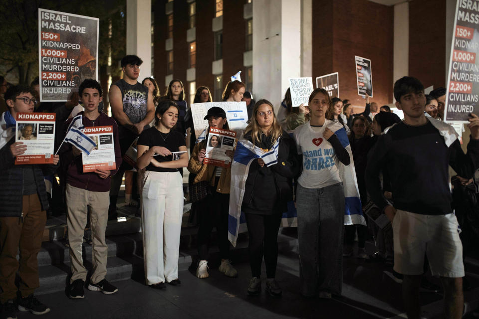 Jewish Rutgers University's students and members of the community gather holding placards and flags to hold solidarity and vigil for Israel on Wednesday, Oct. 25, 2023, in New Brunswick, N.J. For many of the university chaplains and faith leaders caring for students angered and shaken by the Israel-Hamas war, the needs are acute, the days intense. The bloodshed has roiled campuses in the United States, sparking rival rallies and competing demands.(AP Photo/Andres Kudacki)