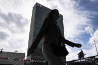 A pedestrian passes along police barricades surrounding the United Nations headquarters, Wednesday, Sept. 22, 2021, during the 76th Session of the U.N. General Assembly in New York. (AP Photo/John Minchillo)