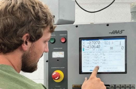 A student is shown in Haywood Community College's Machining and Industrial Systems program which will benefit from $5 million in federal funding.