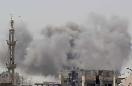 FILE PHOTO: Smoke rises after an air strike during fighting between members of the Syrian Democratic Forces and Islamic State militants in Raqqa, Syria, August 20, 2017. REUTERS/Zohra Bensemra