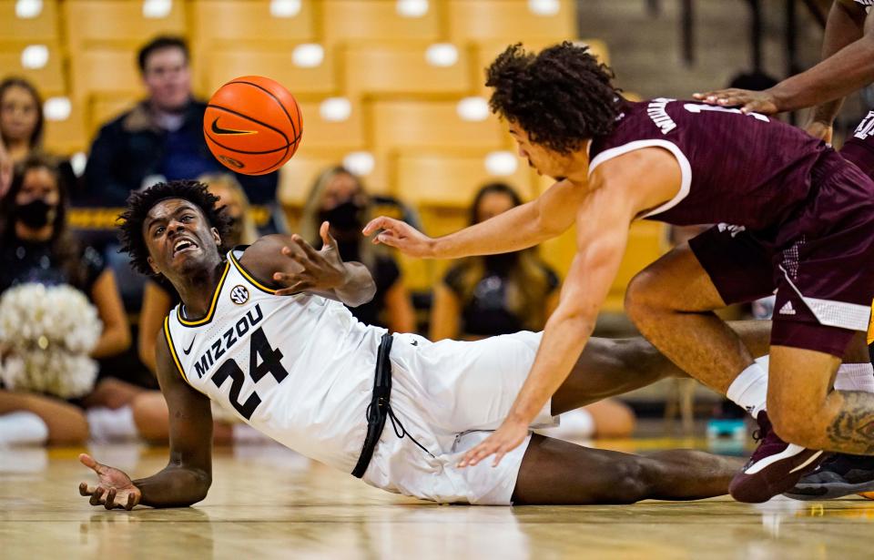 Missouri forward Kobe Brown (24) fights for a loose ball against Texas A&M guard Marcus Williams (1) during a game Saturday at Mizzou Arena.