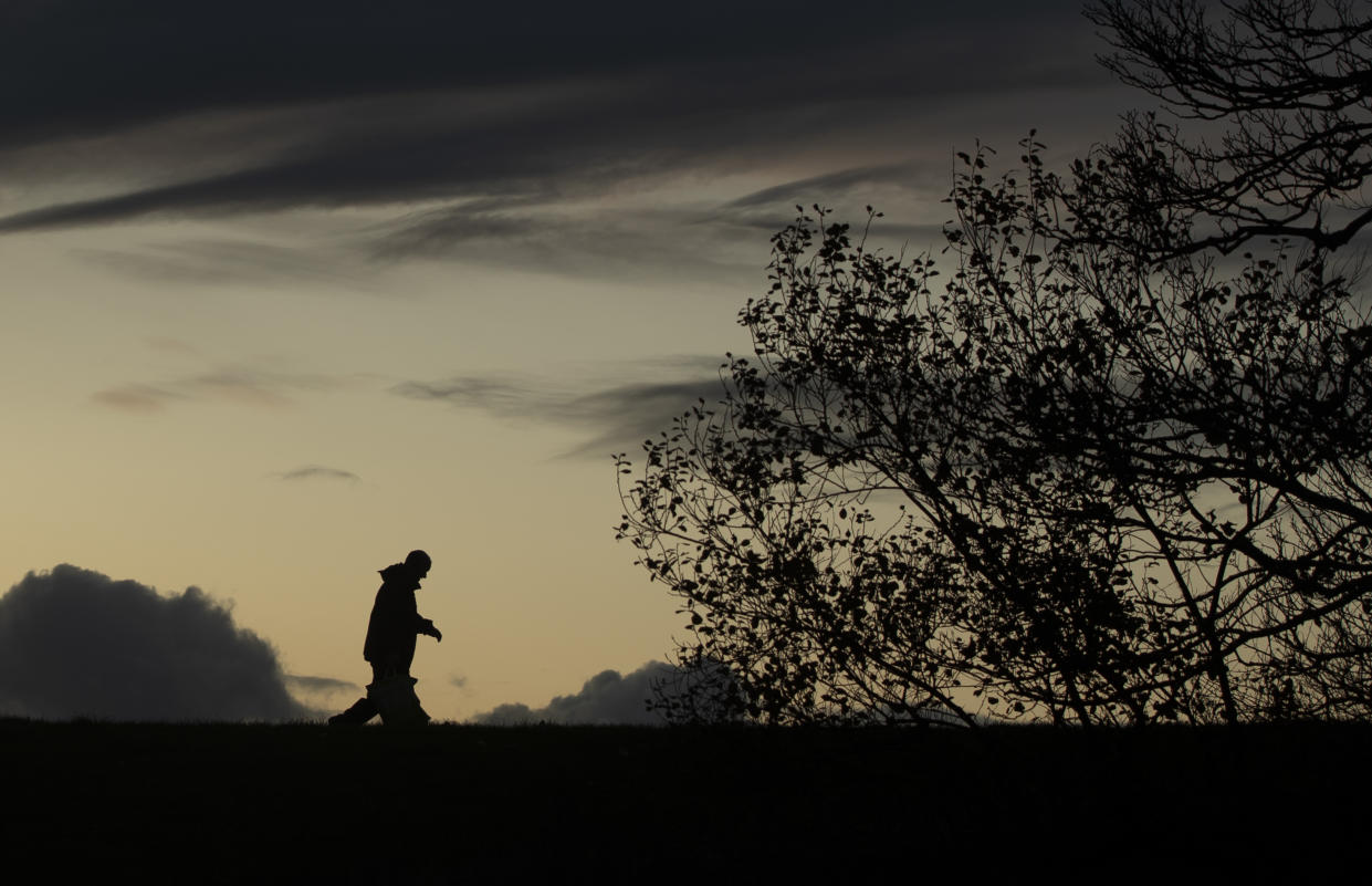 A man walks at sunset in Workington in Cumbria, where earlier today Brexit Party leader, Nigel Farage, addressed supporters at the Washington Central Hotel in an attempt to win over 'Workington man'.