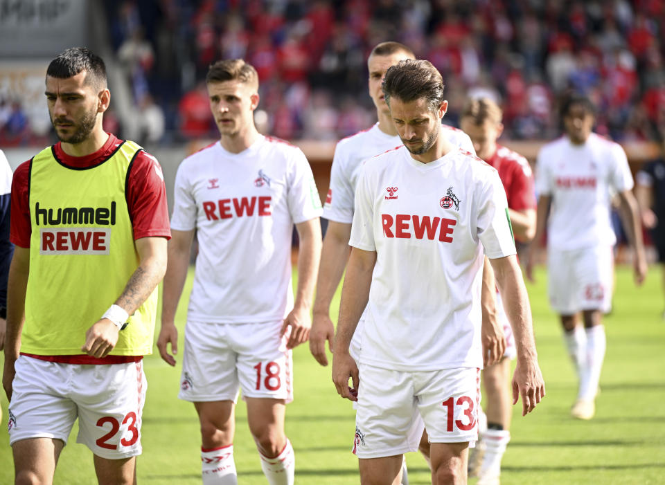 Cologne players leave the pitch after the defeat during the Bundesliga soccer match between Heidenheim and Köln at the Voith-Arena in Heidenheim, Germany, Saturday, May 18, 2024. (Harry Langer/dpa via AP)