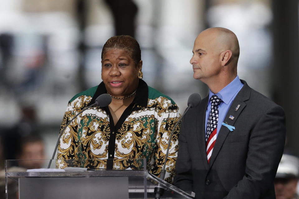 La-Shawn Clark, left, and Mark Cannizzaro read names of victims of the Sept. 11 attacks during a ceremony marking the 17th anniversary on Tuesday, Sept. 11, 2018, in New York. Clark lost her husband, Benjamin Clark, and Cannizzaro lost his cousin, Brian Cannizzaro. (AP Photo/Mark Lennihan)