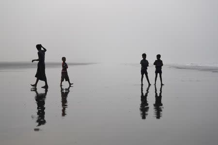 FILE PHOTO - Rohingya refugee children stand on Shamlapur beach after pushing fishing boats out to sea in Cox's Bazaar, Bangladesh, March 24, 2018. REUTERS/Clodagh Kilcoyne