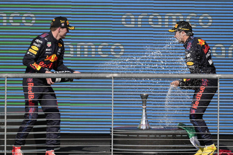 Red Bull drivers Max Verstappen, left, of the Netherlands, and Sergio Perez, of Mexico, celebrate following the Formula One U.S. Grand Prix auto race at Circuit of the Americas, Sunday, Oct. 24, 2021, in Austin, Texas. Verstappen won the race and Perez finished third. (AP Photo/Nick Didlick)