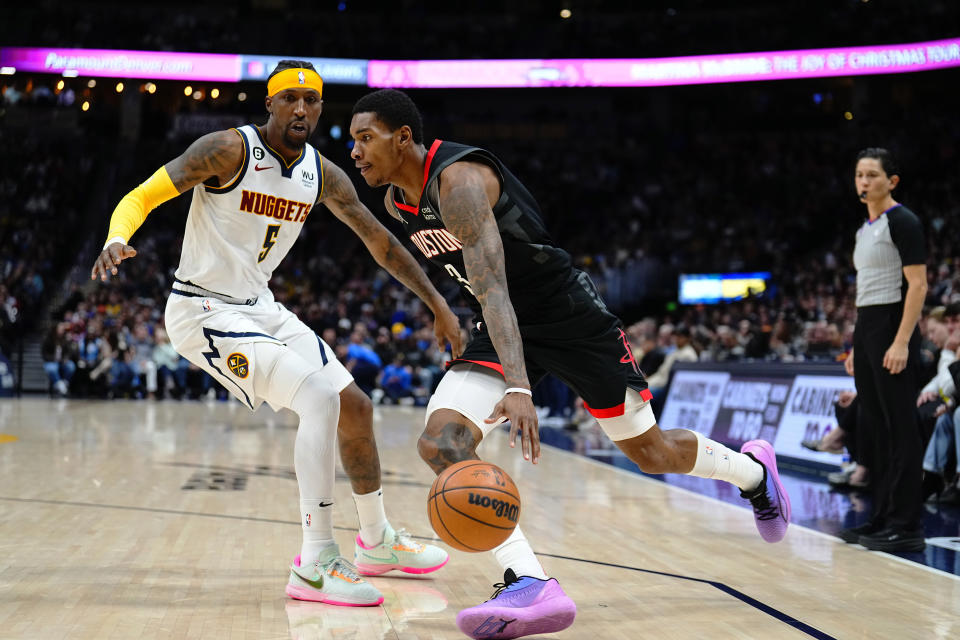 Houston Rockets guard Kevin Porter Jr. (3) drives to the basket against Denver Nuggets guard Kentavious Caldwell-Pope (5) during the second quarter of an NBA basketball game, Wednesday, Nov. 30, 2022, in Denver. (AP Photo/Jack Dempsey)