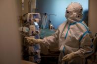 Medical workers treat patients infected with the coronavirus disease (COVID-19) at a hospital in New Delhi