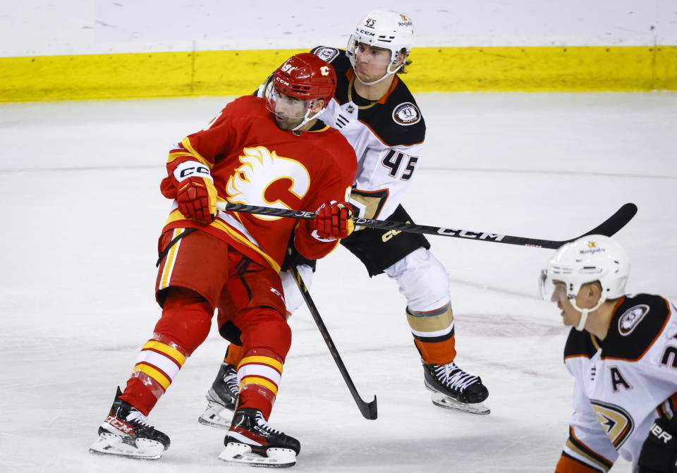 Anaheim Ducks defenseman Colton White, right, checks Calgary Flames forward Nazem Kadri during second-period NHL hockey game action in Calgary, Alberta, Sunday, April 2, 2023. (Jeff McIntosh/The Canadian Press via AP)