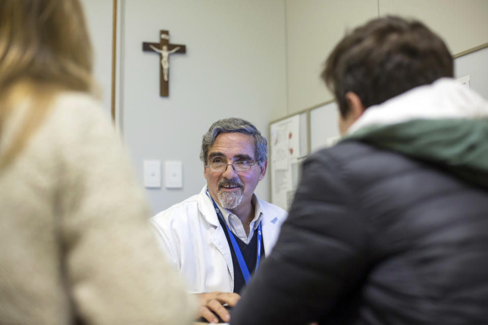 In this July 18, 2018 photo, Ernesto Beruti, chief of obstetrics at the Austral University Hospital, talks with a patient during an appointment in Pilar, Argentina. "Even if the law is passed, I'm not going to eliminate the life of a human being. The most important right is the right to live." said Beruti regarding the measure to expand legal abortion. (AP Photo/Lucia Prieto)