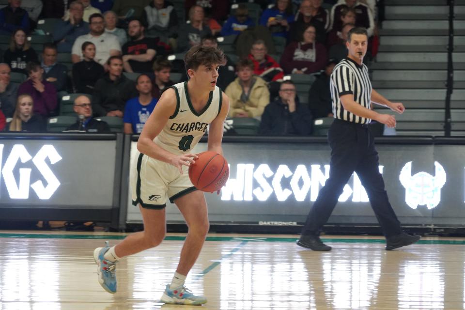 Ryan Thistle of Kettle Moraine Lutheran crosses mid-court during the Chargers’ 67-63 loss to Fox Valley Lutheran Friday at Wisconsin Lutheran College.