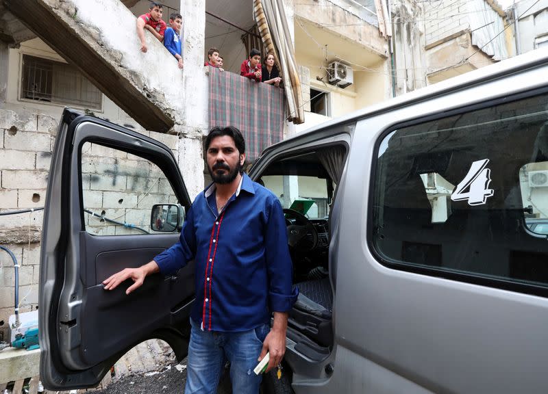 Hassan Zeitar, 39, stands outside his van in Choueifat