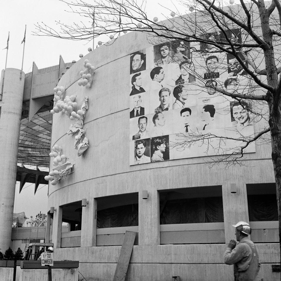 This April 1964 photo provided by The Andy Warhol Foundation for the Visual Arts, Inc. shows a 20x20 foot mural depicting mug shots of the NYPD’s 13 most-wanted criminals by Andy Warhol, mounted on the curved facade of the New York State Pavilion at the 1964 New York World’s Fair in the Queens borough of New York. The fair celebrated “The World of Tomorrow,” but Warhol may have been ahead of his time. His monumental piece commissioned specifically for the fair was deemed too edgy for the family-friendly event and painted over just before opening day. Now, 50 years later, the work is the focus of a museum exhibition being staged on the very fairgrounds where the pop-art provocateur was infamously censored. (AP Photo/The Andy Warhol Foundation for the Visual Arts, Inc./Artists Rights Society)