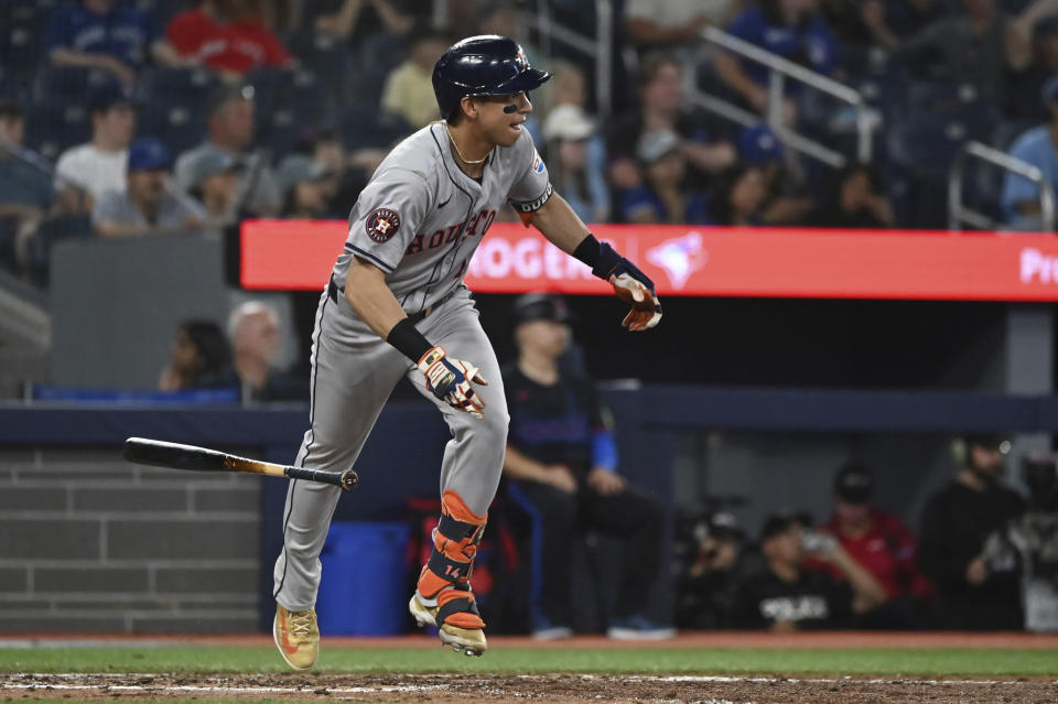 Houston Astros' Mauricio Dubon (14) hits a single against the Toronto Blue Jays during the ninth inning of a baseball game in Toronto on Wednesday, July 3, 2024. (Jon Blacker/The Canadian Press via AP)