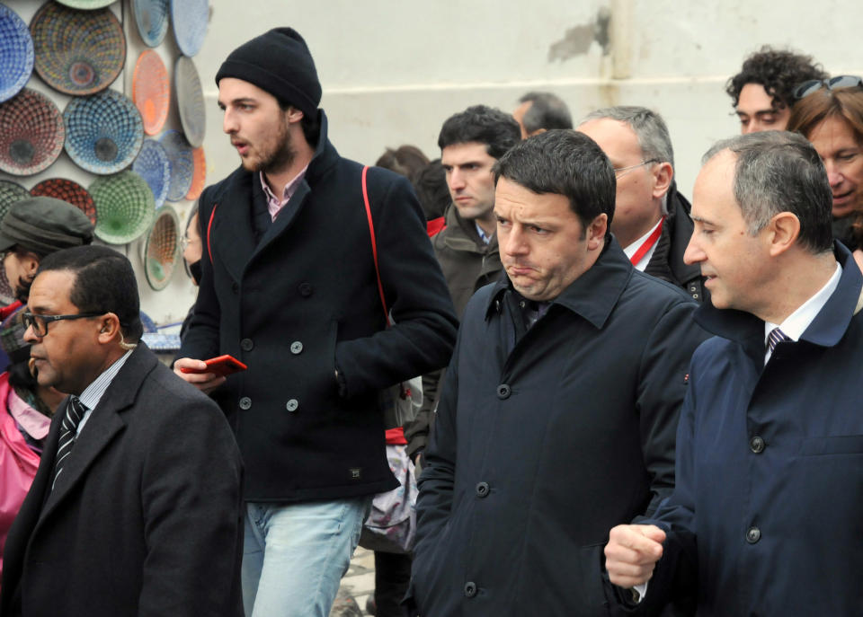Italian Premier Matteo Renzi , second from right, walks with an unidentified official in the streets of Sidi Bou Said, north of Tunis, after a meeting with members of Tunisian civil society, Tuesday, March 4, 2014. Earlier in the day Renzi met the Tunisian President, Moncef Marzouki, and his Tunisian counterpart, Mehdi Jomaa. Man at right is unidentified. (AP Photo/Hamadi Ben Taieb)