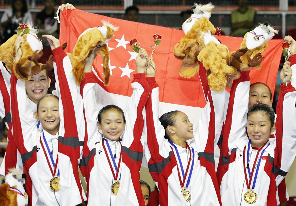 Members of Singapore's women gymnastic team, (L to R) Lee Wen Si, Lee Wen Ling, Tabitha Tay Jia Hui, Nicole Tay Xi Hui, Lim Heem Wei and Nur Atikah Nabilah, celebrate after winning the gold medal in the women's gymnastics team competition at the 23rd Southeast Asian Games in Manila on November 29, 2005. Singapore won the gold medal, while Vietnam took home the silver and Malaysia the bronze. REUTERS/Bazuki Muhammad