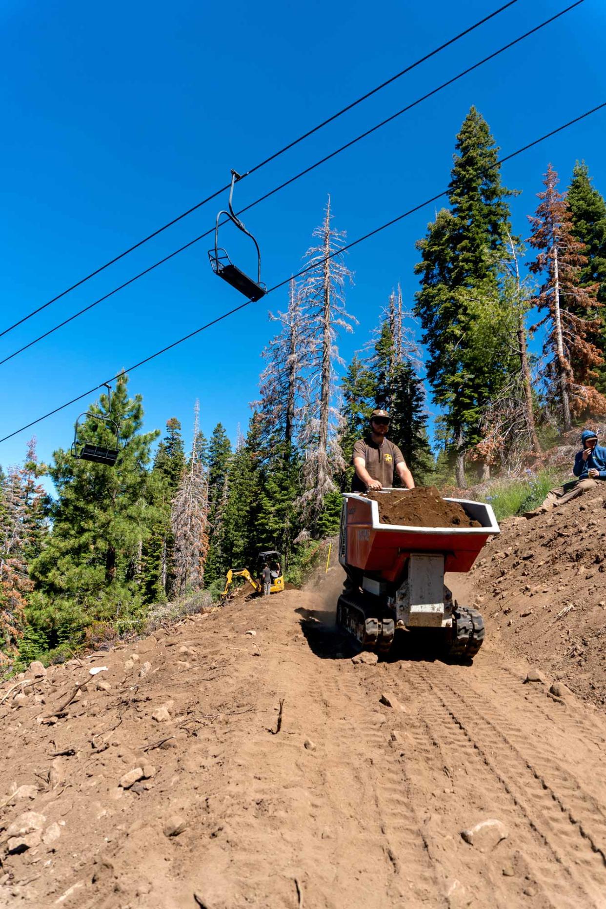 Pro crew works on trail underneath one of Dodge Ridge’s chairlifts