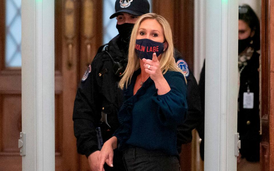 Representative Marjorie Taylor Greene (R-GA) shouts at journalists as she goes through security outside the House Chamber at Capitol Hill in Washington, DC - AFP
