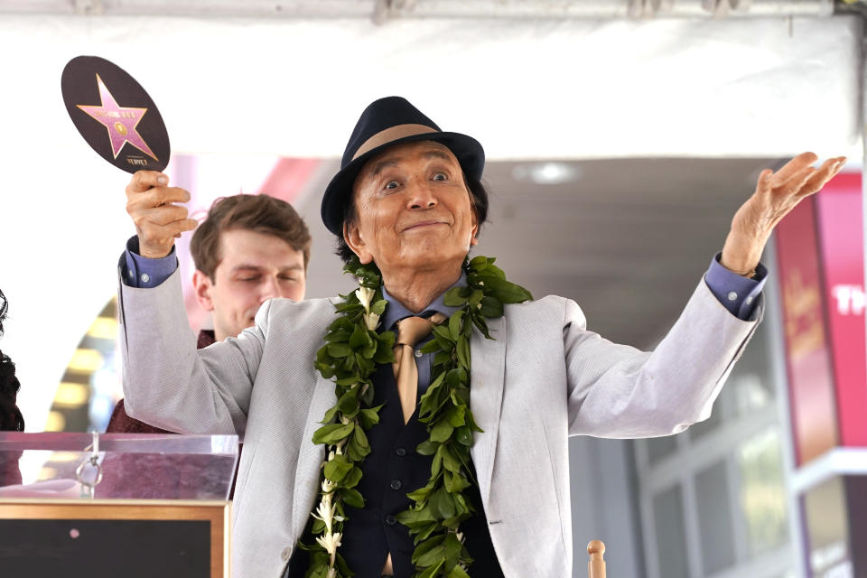 FILE - Actor James Hong gestures at a ceremony honoring him with a star on the Hollywood Walk of Fame on May 10, 2022, in Hollywood section of Los Angeles. Hong has a starring role in the new “Gremlins” animated prequel, “Secrets of the Mogwai,” and pops up in “American Born Chinese” on Disney+. (AP Photo/Mark J. Terrill, File)