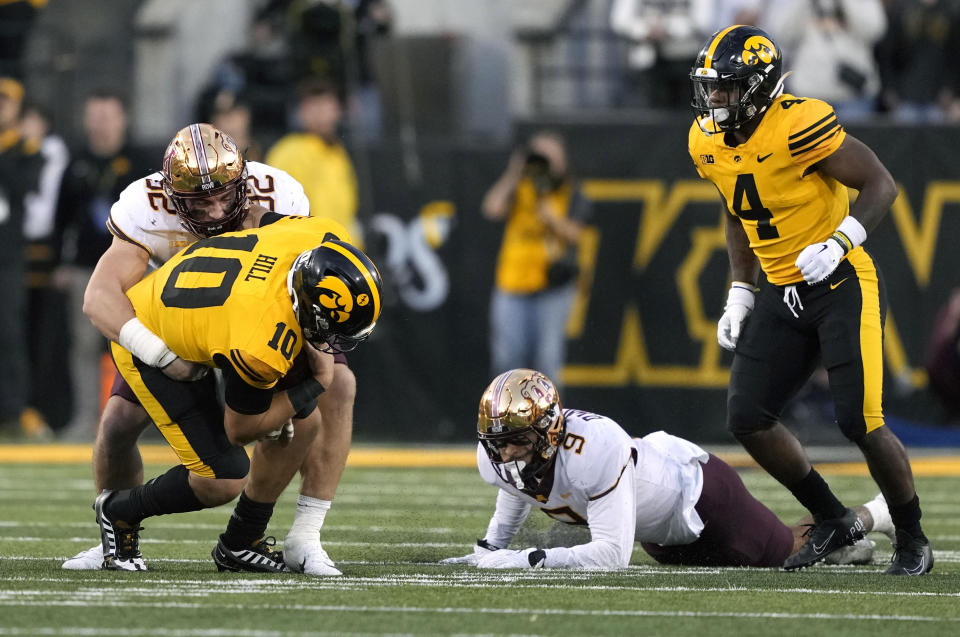 Minnesota defensive lineman Danny Striggow (92) sacks Iowa quarterback Deacon Hill (10) during the second half of an NCAA college football game, Saturday, Oct. 21, 2023, in Iowa City, Iowa. (AP Photo/Matthew Putney)