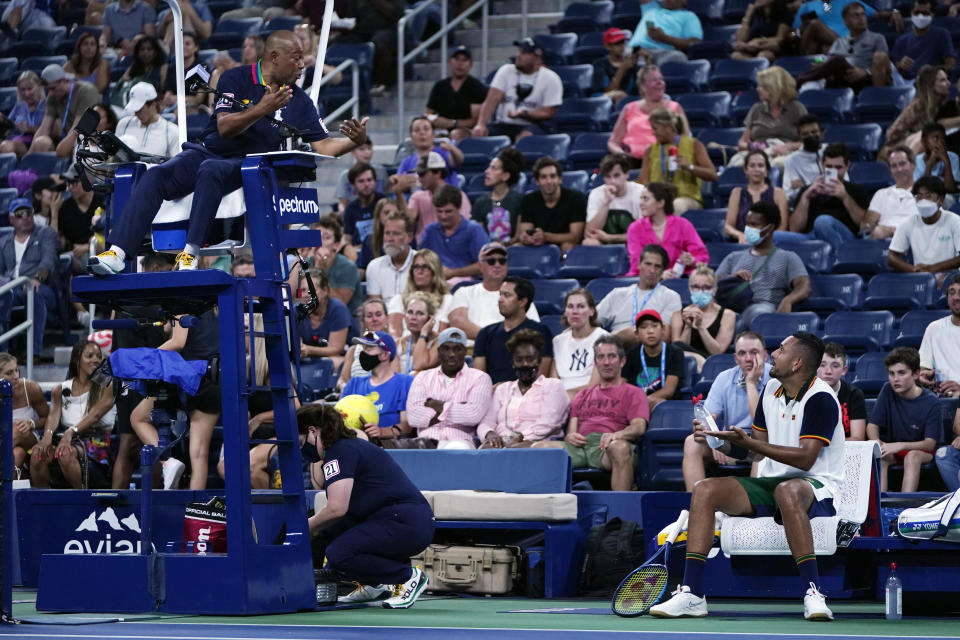 The chair umpire has words with Nick Kyrgios, of Australia, during the first round of the US Open tennis championships, Monday, Aug. 30, 2021, in New York. (AP Photo/Frank Franklin II)