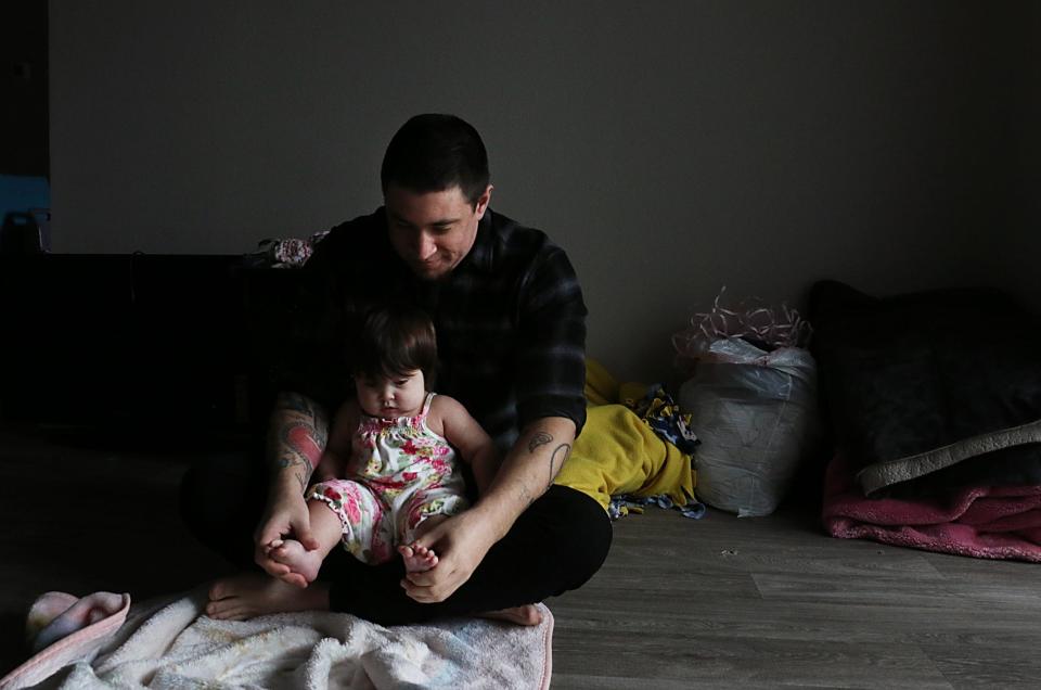 Elijah Johnson plays with his daughter Azriela-Nova in their apartment in Reno on March 28, 2023.