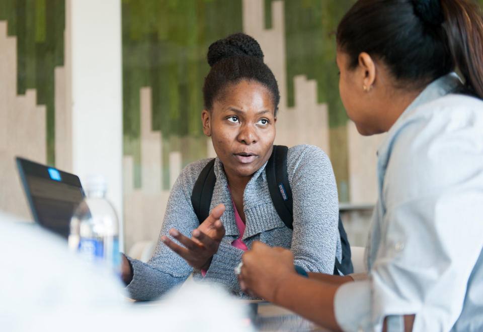 Hilta Tanis (left) talks to healthcare&nbsp;navigator Sandra Wells during an open enrollment event at the University of South Florida in Tampa. (Photo: Chris McGonigal/HuffPost)