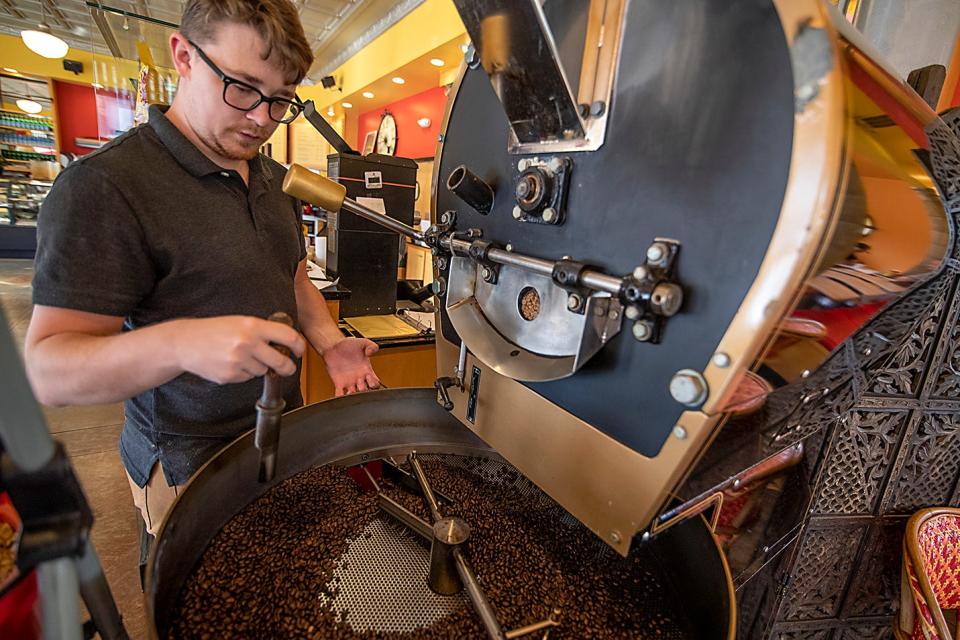 Innkeeper's Fresh Roasted Coffee employee Thomas Berry stirs coffee beans on Thursday, July 22, 2021.