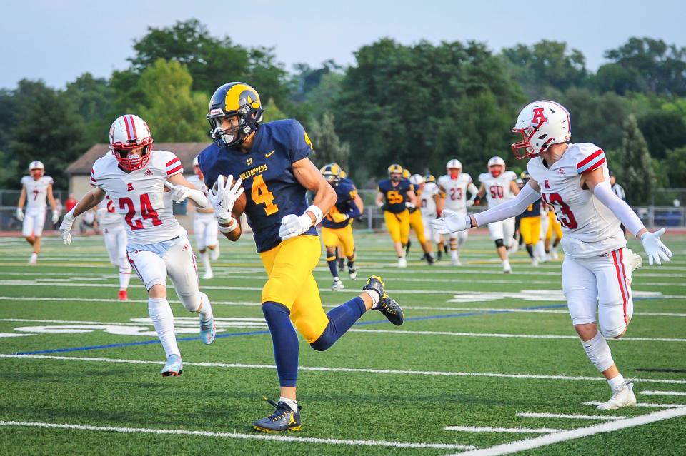 Marquette wide receiver Cam Russell outruns Arrowhead defensive backs Luke Patterson (13) and Connor Foley (24) for a 49-yard touchdown catch during the first quarter of a game Friday, August 18, 2023, at Hart Park in Wauwatosa, Wisconsin.