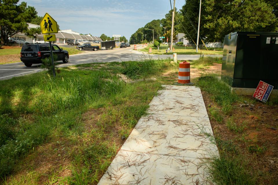 A contractor has stopped building a 1.2-mile sidewalk between the Food Lion on Rosehill Road and Shaw Mill Road.  It stops after a half mile at Rutledge Drive, opposite Trinity Christian School.