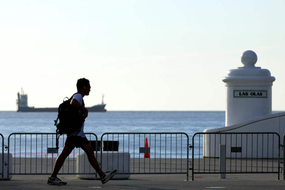 A man walks on the inside of barricades set up along the Florida Panthers Stanley Cup Celebration parade route on Fort Lauderdale Beach on Friday, June 28, 2024. (Amy Beth Bennett /South Florida Sun-Sentinel via AP)