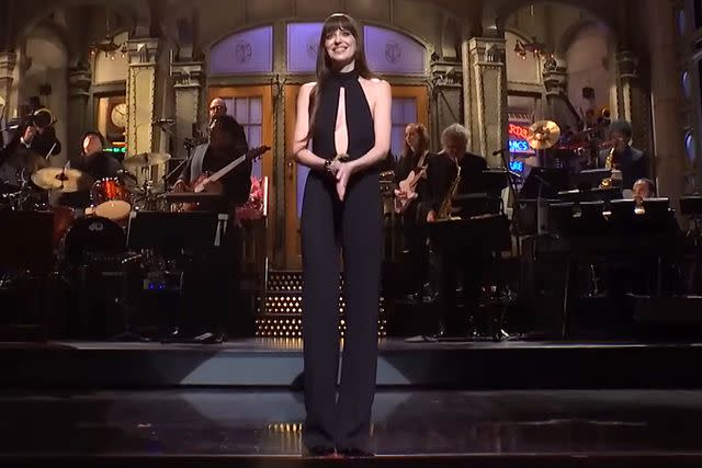 <p>SNL/YouTube</p> Dakota Johnson on stage in Tom Ford during her opening monologue for 'Saturday Night Live' on Saturday Jan. 27