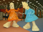 Athena (L) and Phevos (R), the Offical Mascots of the Athens 2004 Olympic Summer Games, walk through the lobby of the Main Press Center (MPC) prior to the start of games. (Scott Halleran/Getty Images)