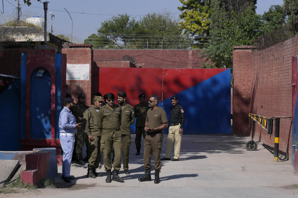 Police officers stand guard outside the Adiyala prison, where the special court hearing of Cipher case against Pakistan's former Prime Minister Imran Khan, is held at the Adiyala prison, in Rawalpindi, Pakistan, Monday, Oct. 23, 2023. A Pakistani court on Monday indicted Khan on charges of revealing official secrets after his 2022 ouster from office in another slap to the former prime minister who will likely be unable to run in the upcoming parliamentary elections in late January. (AP Photo/Anjum Naveed)