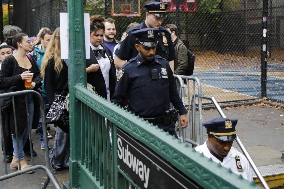 Police officers descend to the subway in preparation for the Greenwich Village Halloween Parade, Thursday, Oct. 31, 2019, in New York. (AP Photo/Frank Franklin II)