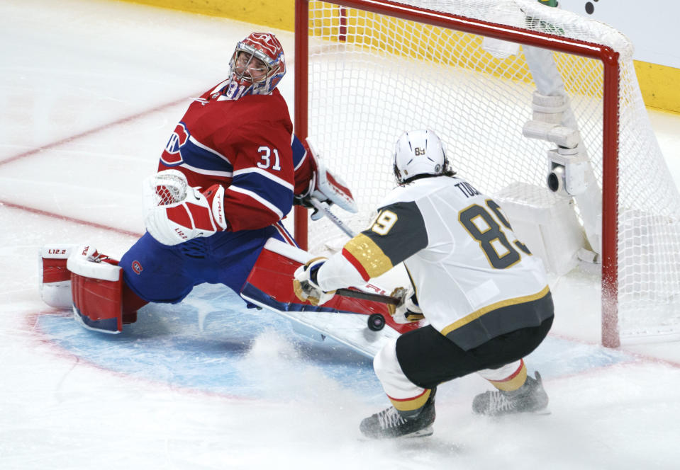 Montreal Canadiens goaltender Carey Price makes a save on Vegas Golden Knights' Alex Tuch during the third period of Game 3 of an NHL hockey semifinal series, Friday, June 18, 2021, in Montreal. (Paul Chiasson/The Canadian Press via AP)