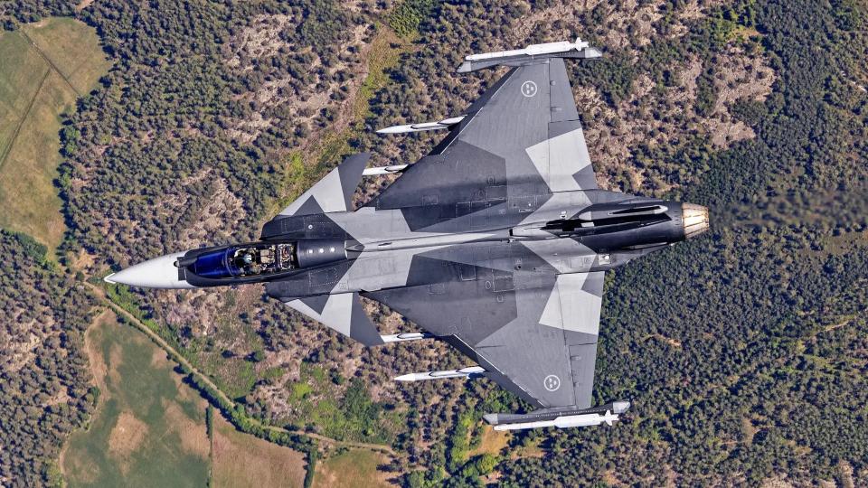 A Saab Gripen E fighter. The jet's wing tip pods, which are part of the aircraft's Arexis electronic warfare suite, are seen with IRIS-T missiles loaded into their integral launch rails. <em>Saab</em>