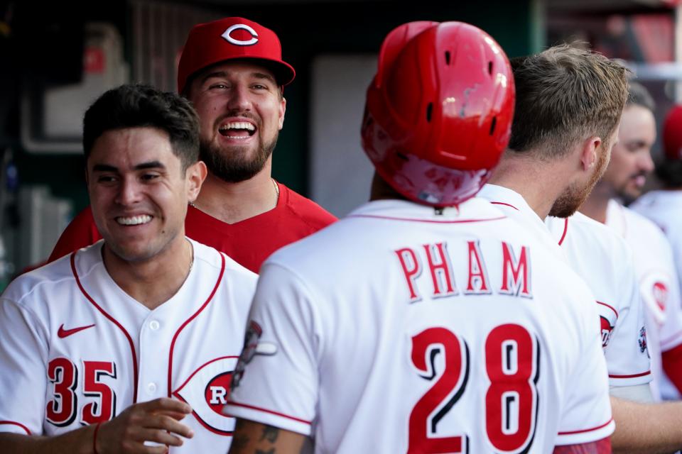 Cincinnati Reds second baseman Alejo Lopez (35) and Cincinnati Reds starting pitcher Graham Ashcraft (51) share a laugh with Cincinnati Reds left fielder Tommy Pham (28)  after he hit a two-run home run in the first inning of a baseball game against the Washington Nationals, Friday, June 3, 2022, at Great American Ball Park in Cincinnati. 