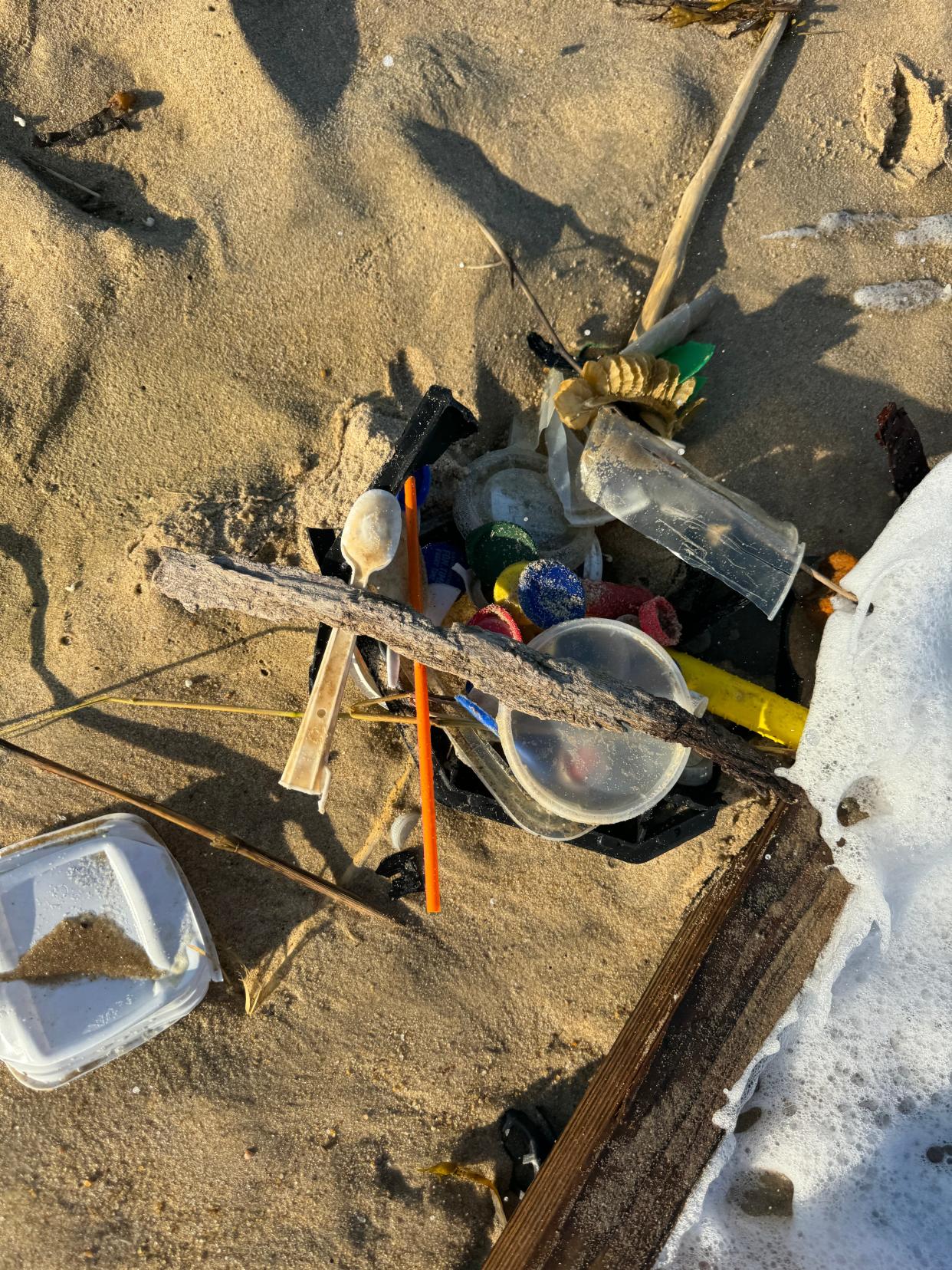 Trash gathered into a pile by beachgoers in Fenwick Island, Sunday, Sept. 15, 2024.