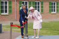 CORRECTS SPELLING OF NAME The Danish Queen Margrethe cuts the ribbon with museum director Claus Kjeld Jensen, during the inauguration of the new museum Flugt, in Oksboel, Denmark, Saturday 25 June 2022. Flugt — Refugee Museum of Denmark was created on the site of a camp in Oksboel, a town in southwestern Denmark, that housed up to 100,000 refugees from Germany in the postwar years. Flugt — which means escape in Danish — also tells the story of immigrants from Iran, Lebanon, Hungary, Vietnam and elsewhere who fled their homelands and found shelter in the Scandinavian country. (Bo Amstrup/Ritzau Scanpix via AP)