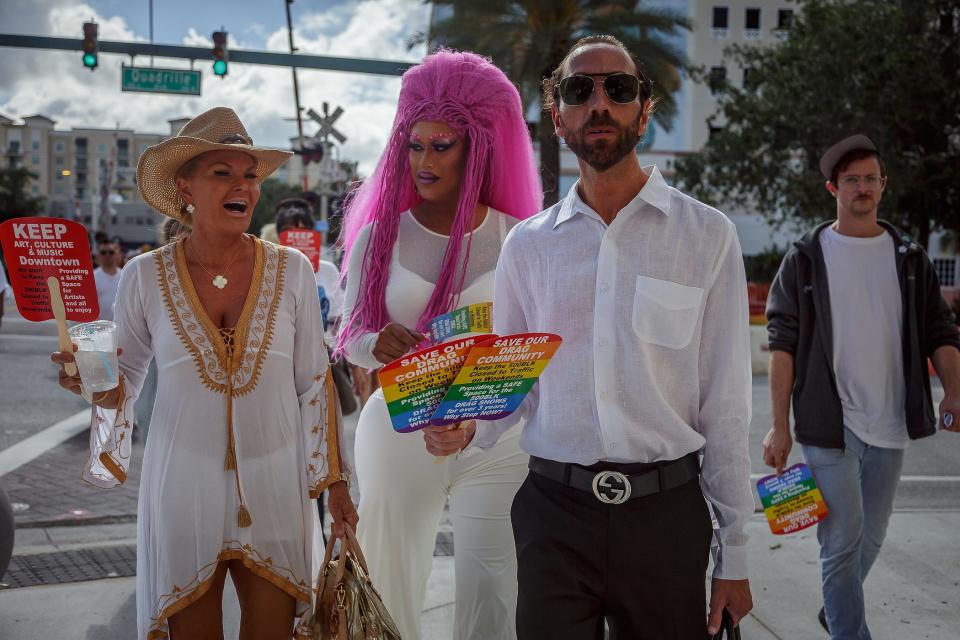 Left to right: Joy Westrum, West Palm Beach, Edgar Rivas, Stuart, Chris Rhodes, West Palm Beach walk on Clematis Street to the city commission meeting at city hall in downtown West Palm Beach, Fla, on April 17, 2023.