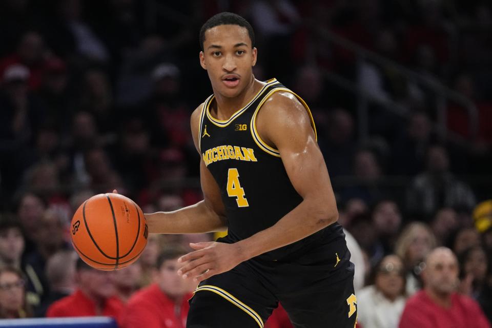Michigan's Nimari Burnett looks to pass the ball during the first half of an NCAA college basketball game against St. John's, Monday, Nov. 13, 2023, in New York. (AP Photo/Frank Franklin II)