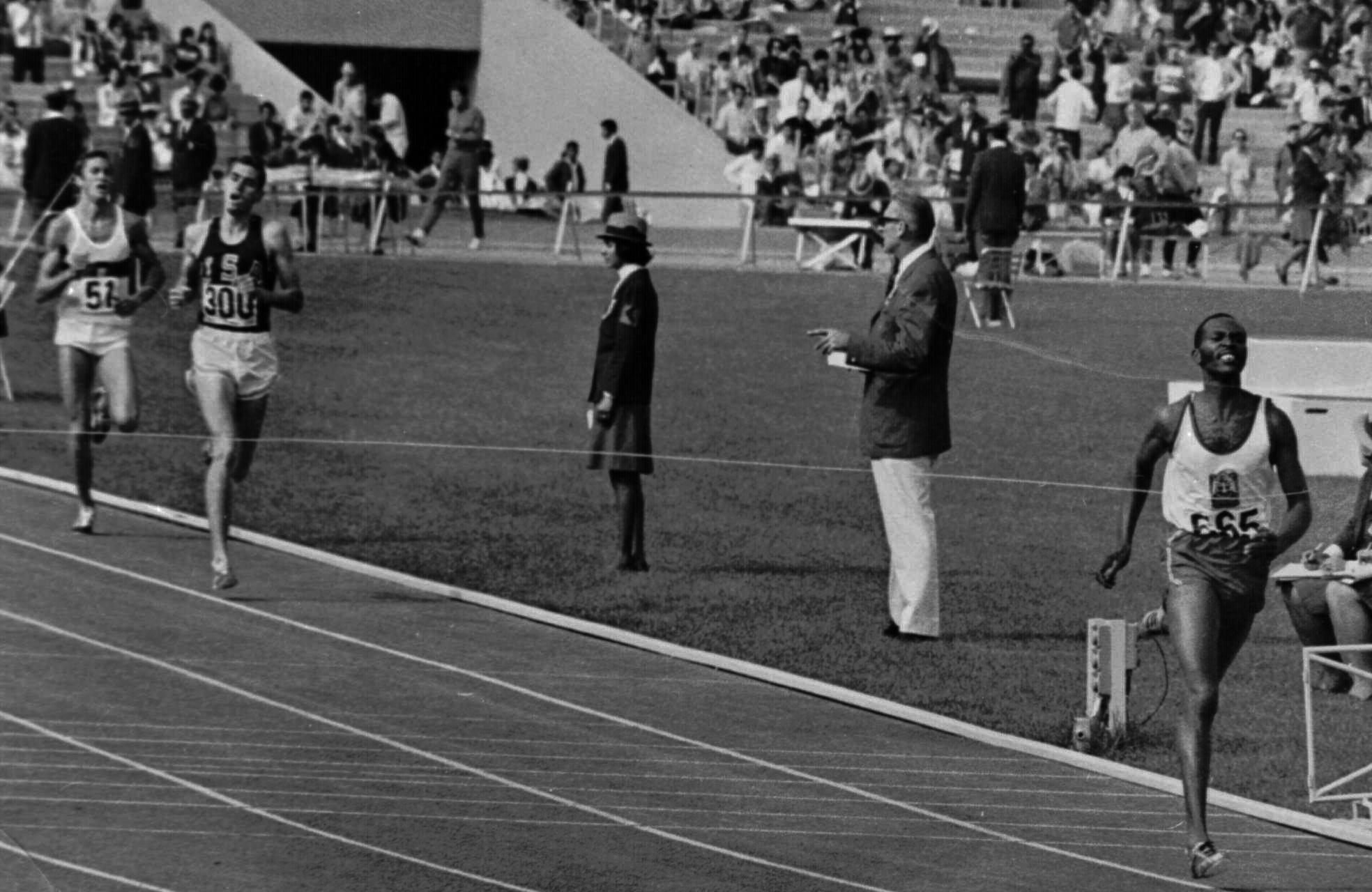 Kipchoge Keino of Kenya hits the finish line of the 1968 Olympic 1500 Meter run Oct. 20, 1968 in 3 minutes, 34.9 sedconds for a new Olympic record. Fifteen yards back in second place is Jim Ryun of the U.S., world record holder for the event, who could not overtake Keino in the last lap. Behind Ryun is Bodo Tummler of West Germay, who placed third.(AP Photo)