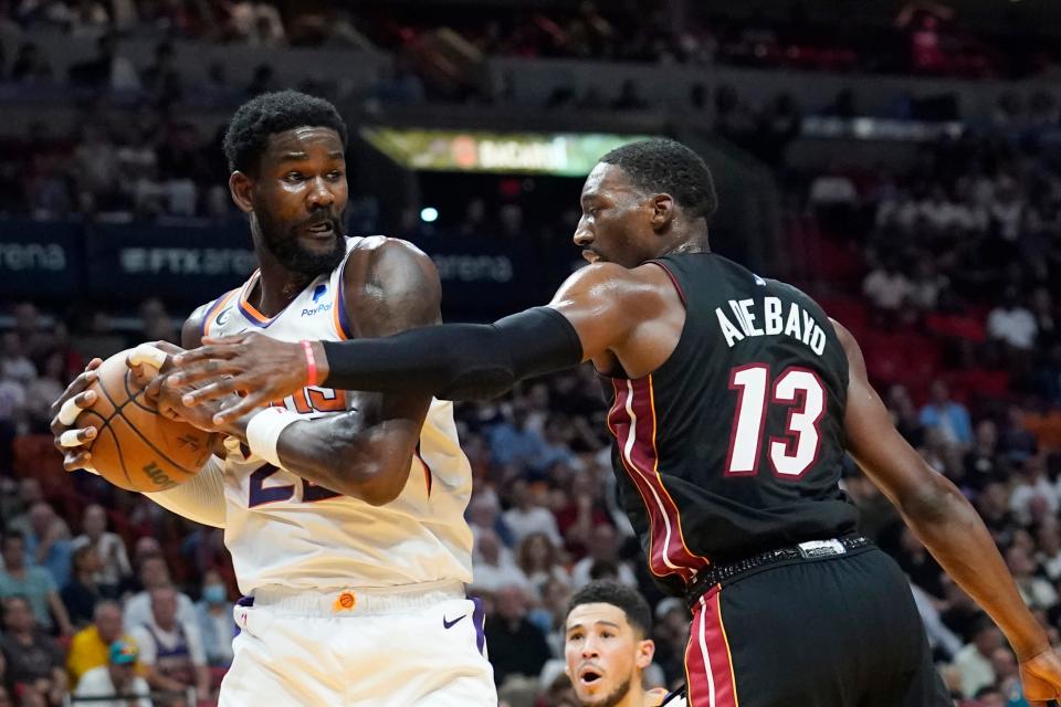 Phoenix Suns center Deandre Ayton (22) grabs a rebound as Miami Heat center Bam Adebayo (13) defends during the first half of an NBA basketball game Monday, Nov. 14, 2022, in Miami. (AP Photo/Marta Lavandier)