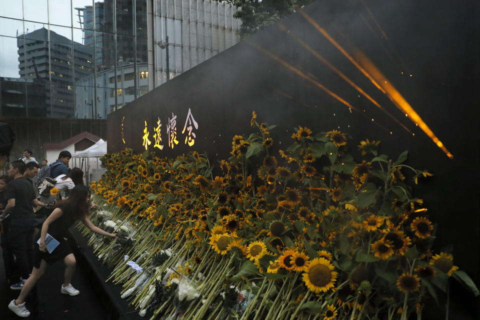 Attendees take part in a public memorial for Marco Leung, the 35-year-old man who fell to his death weeks ago after hanging a protest banner against an extradition bill, in Hong Kong, Thursday, July 11, 2019. The parents of Leung have urged young people to stay alive to continue their struggle. (AP Photo/Kin Cheung)