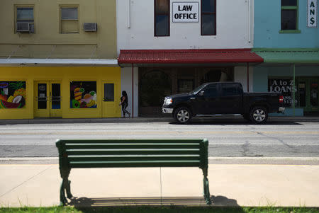 A woman walks through downtown Carizzo Springs, Texas, U.S. September 5, 2018. Picture taken September 5, 2018. REUTERS/Callaghan O'Hare