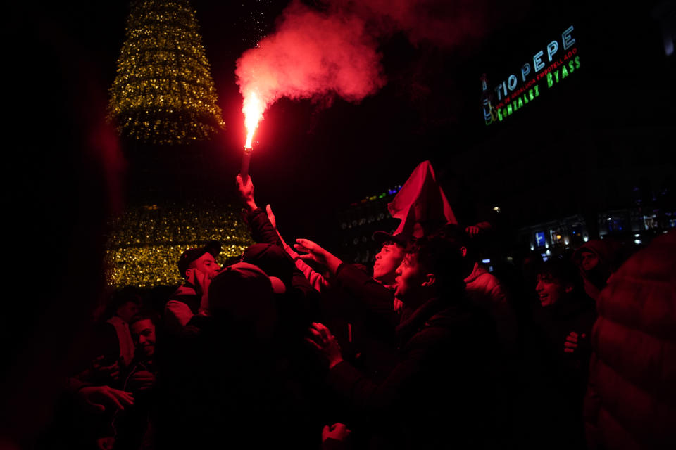 Morocco fans celebrate in the central Puerta del Sol in Madrid, Spain, Tuesday, Dec. 6, 2022. Morocco beat Spain on penalties during a round of 16 World Cup soccer tournament in Qatar. (AP Photo/Andrea Comas)